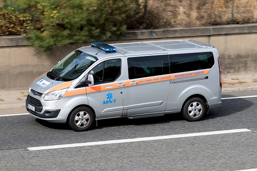 Frankfurt am Main, Germany - September 22, 2018: MNT van with active blue emergency vehicle lighting on motorway