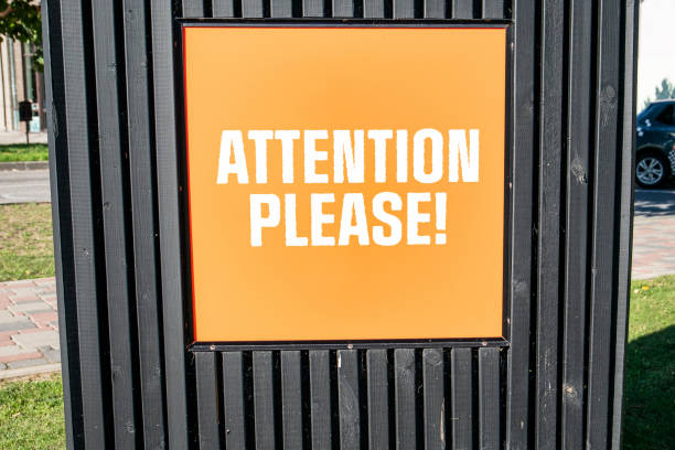 istock ATTENTION PLEASE. Orange advertising sign with text 1789609503