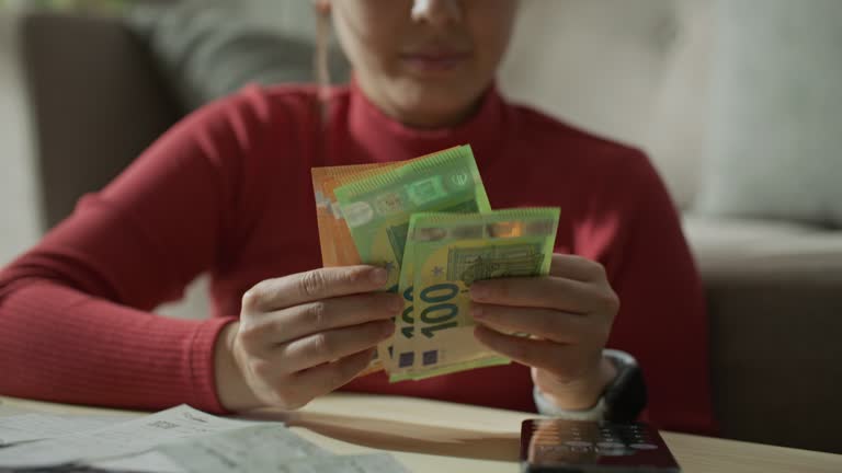 Counting Euro cash money in female hands on the table