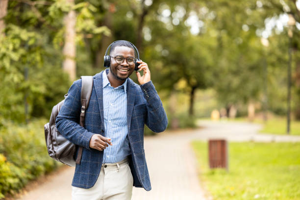 istock Cheerful man with headphones listening to music while going to work. 1789611216