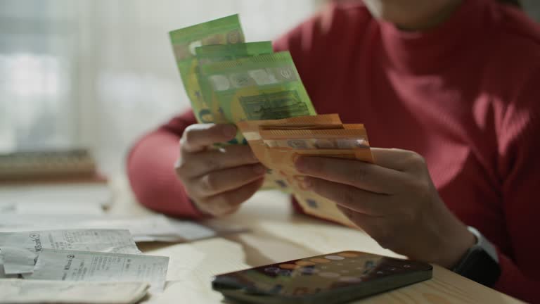 Counting Euro cash money in female hands on the table