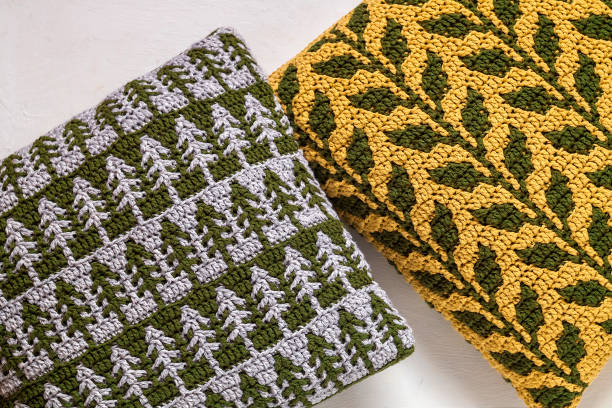 istock Handmade crochet warm pillows with botanical pattern on a white background, 1789612863