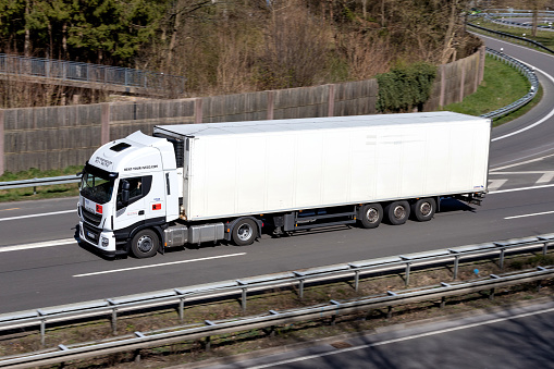 Wiehl, Germany - April 4, 2020: Iveco Rent truck with temperature controlled trailer on motorway