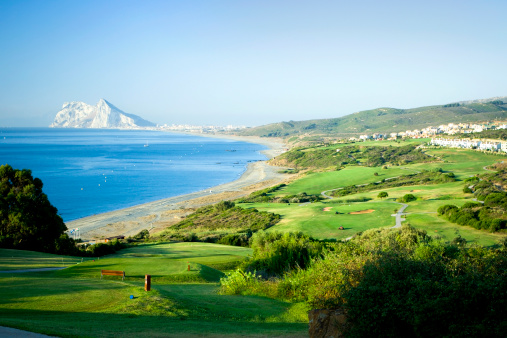 A golf course along the Southern Coast of Spain with Gibraltar in the distance.
