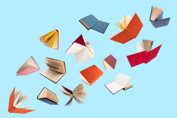 istock Colorful hardcover books flying isolated on blue background. 1789640764
