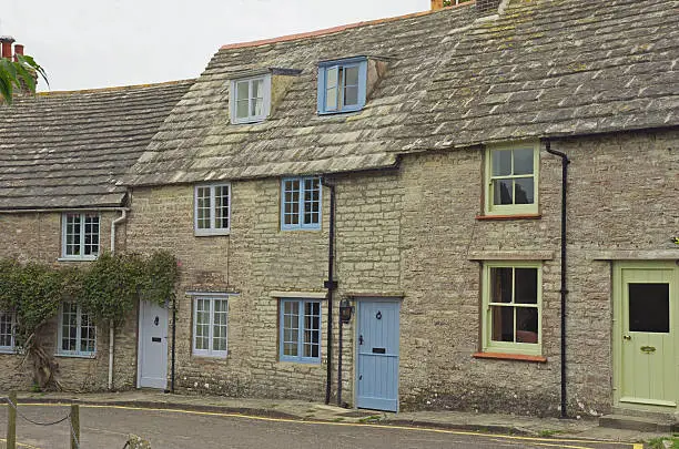 A Purbeck stone row of cottages made with local stone.