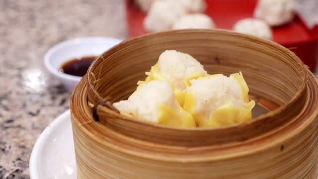 Thai steamed dumplings gently cooked in bamboo steamer served in a plate,