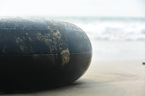 istock Round rubber buoy on sand and sea water waves 1789648921