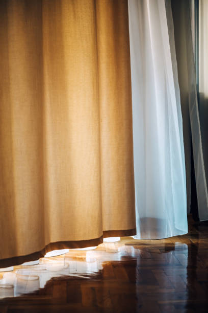 istock Wavy curtains in bedroom making shade from summer sunlight 1789649495