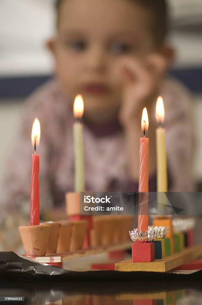 girl look at the Hanukkah menorah Candle Stock Photo