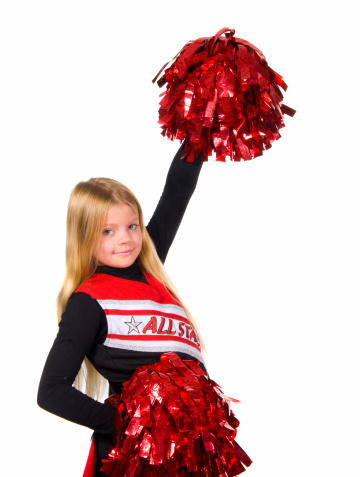 Young cheerleader smiling at camera shot over white