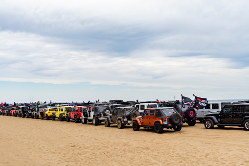 Virginia Beach, VA, USA - November 11, 2023
Long rows of jeeps are seen on the beach at the annual Jeep Fest held at Virginia Beach, VA. Gathering of Jeep owners from across the country come to meet fellow jeep owners and practice new driving skills.