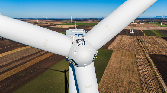 Aerial drone footage of windmills on a sunny day with a beautiful blue sky - HDR Photos - Close-up