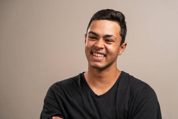 istock Young man with oriental features smiling on pastel background. 1789657215