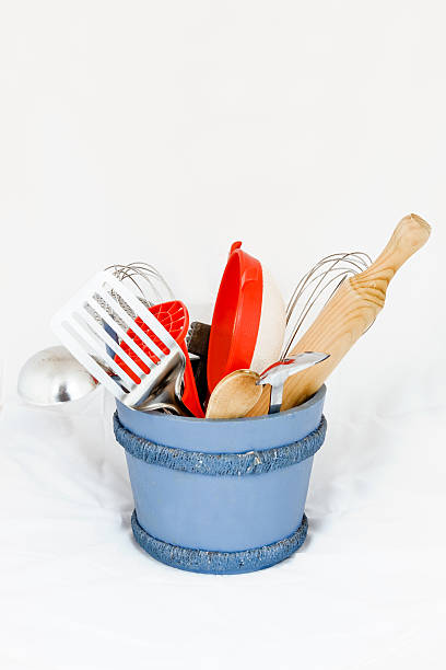 KItchen utensiles in a wooden bucket stock photo
