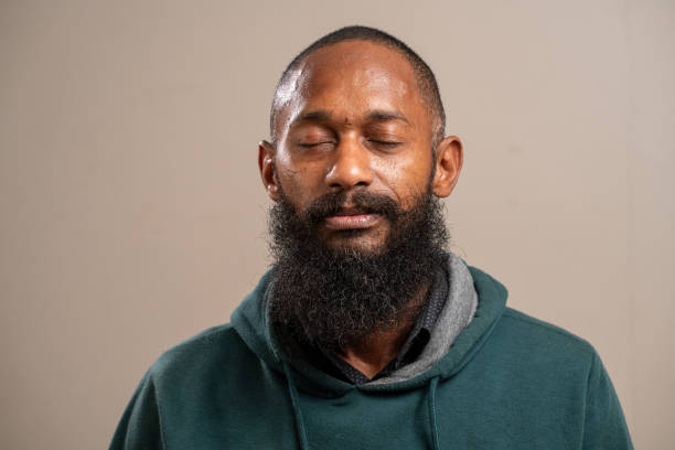 istock Bearded black man with closed eyes on pastel background. 1789658291