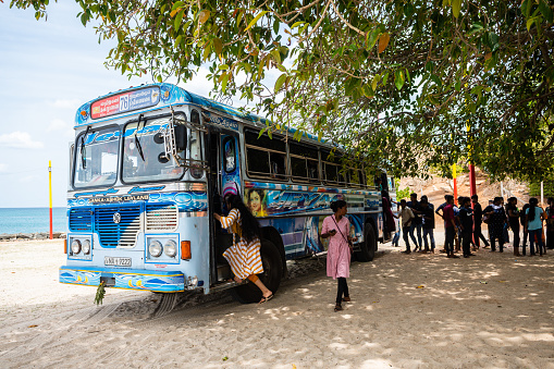 trincomalee, sri lanka. 14th august, 2023: a local bus stopped in front of trincomalee beach, sri lanka