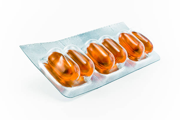 istock Strip of orange cold flu medicine pills 178966701