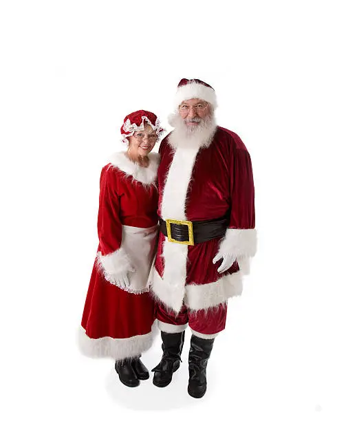 The REAL Santa Claus stands with his arm around Mrs. Claus.