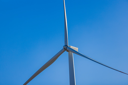 A wind turbine farm produces green energy, supporting eco-friendly practices and sustainable technology in nature.