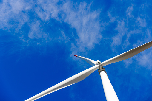 A wind turbine farm produces green energy, supporting eco-friendly practices and sustainable technology in nature.