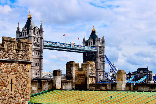 Tower Bridge with historic towers and building roofs in the foreground
