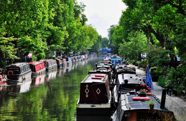 istock Canal Boats along a Tree-Lined Waterway in London 1789692128
