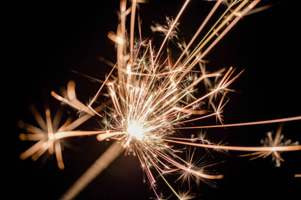 istock A handheld firework, a single sparkler emitting warm light sparks of light fanning out into individual star shapes 1789695252