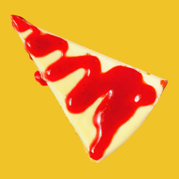 istock A piece of triangular cheesecake with strawberry jam on top on a yellow background. 1789709809