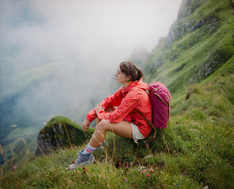 Determined woman  hiking on mountain ridge in Swiss Alps
