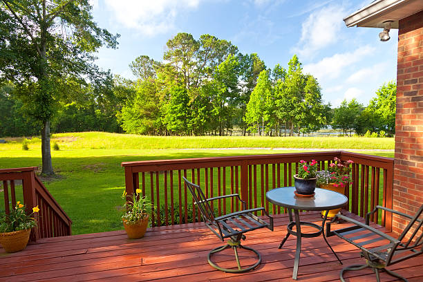 Backyard deck with large green yard Residential backyard deck overlooking lawn and lake wooden porch stock pictures, royalty-free photos & images