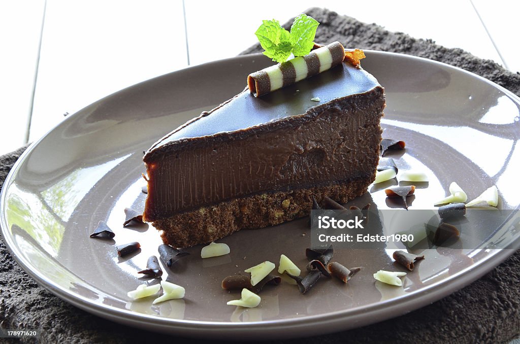 Chocolate Cheesecake A slice of chocolate cheesecake on a plate. Cake Stock Photo
