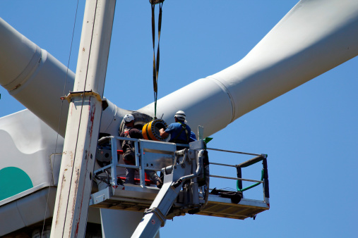 Operators do maintenance work on the turbine of a wind turbine
