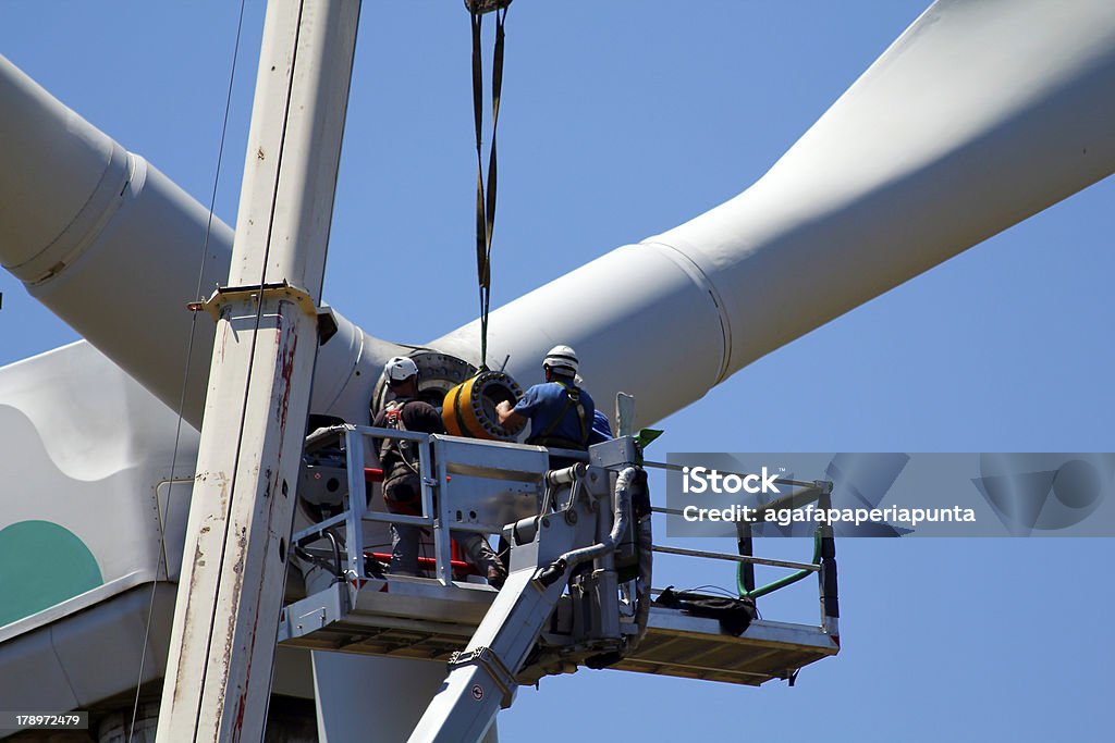 Repairing a wind turbine Operators do maintenance work on the turbine of a wind turbine Wind Turbine Stock Photo