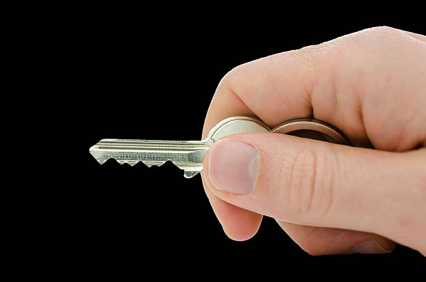 istock Male hand holding house key 178973082