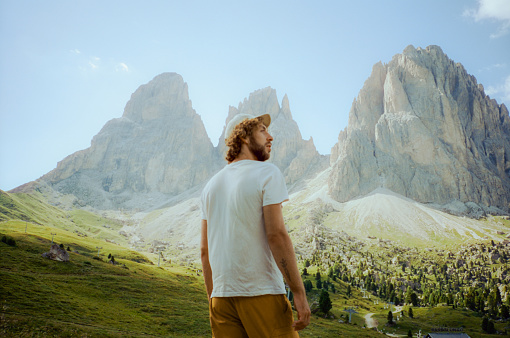 Serene man hiking in Dolomites in summer. Shot on camera film