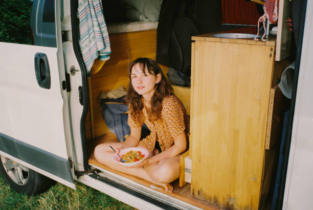istock Woman eating sitting in camper van 1789735077