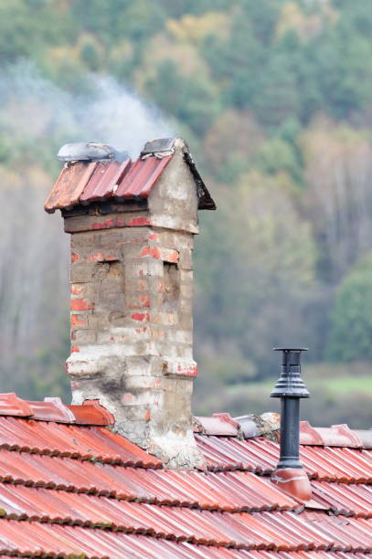 istock Vintage collapsing chimney with dark smoke on the countryside. 1789750242