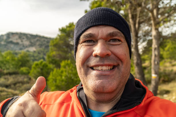 istock Happy man takes a selfie on the mountain at sunset. 1789751785