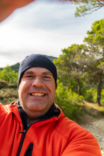 istock Happy man takes a selfie on the mountain at sunset. 1789751823