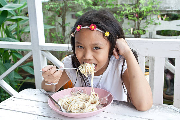 istock Girl eating spaghetti. 178976882