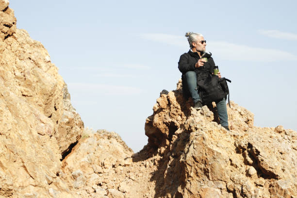 istock man walking, climbing, sitting and resting on the mountainside 1789774954