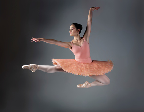 Ballet dancer with pink tutu en-pointe.