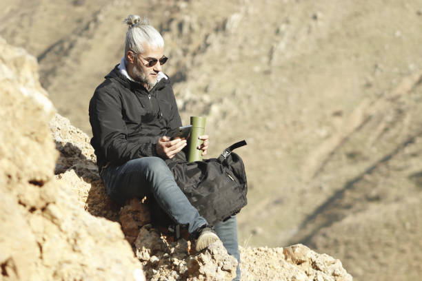 istock man walking, climbing, sitting and resting on the mountainside 1789778658