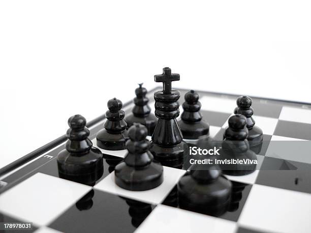 Black Chess King Stands On A Board With Figures Stock Photo - Download Image Now - Activity, Advertisement, Aggression