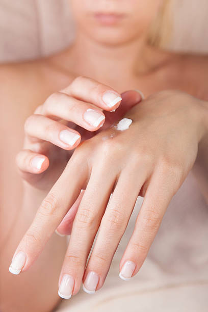 istock female applying cream on her hands 178978231