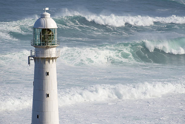 Kommetjie Lighthouse Cape Town Large swells behind Kommetjie lighthouse near Cape Town kommetjie stock pictures, royalty-free photos & images