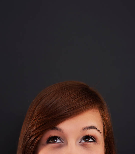 istock Young woman looking up at blackboard 178979545