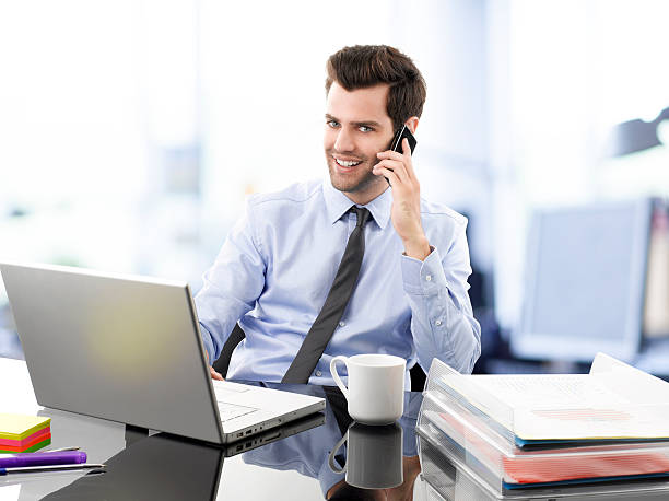 istock A business man talking on the phone and smiling 178979590