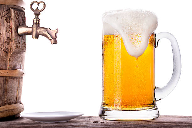 Glass of beer with barrel on a wooden table Glass of beer with barrel on a wooden table white background unbolted stock pictures, royalty-free photos & images